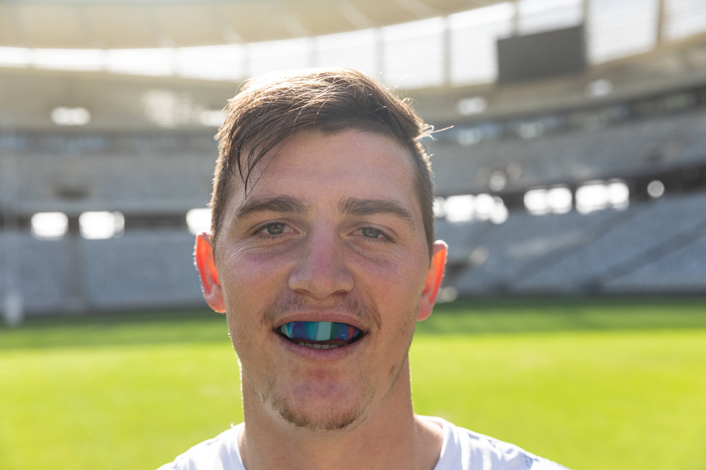 Male rugby player with mouth guard in stadium