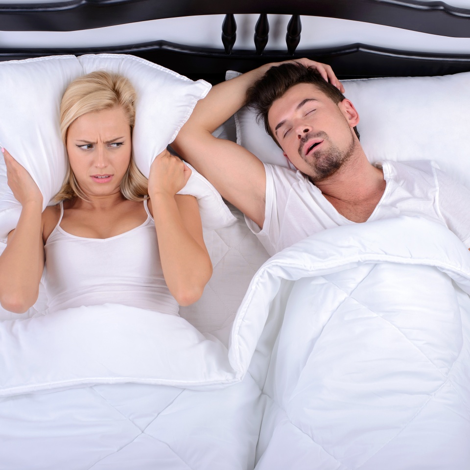 Young woman can not sleep through the snoring of her husband in her bedroom
