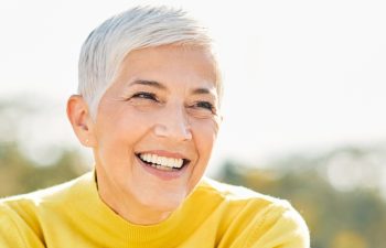 Portrait of an elderly woman outdoors. Happy senior woman in park