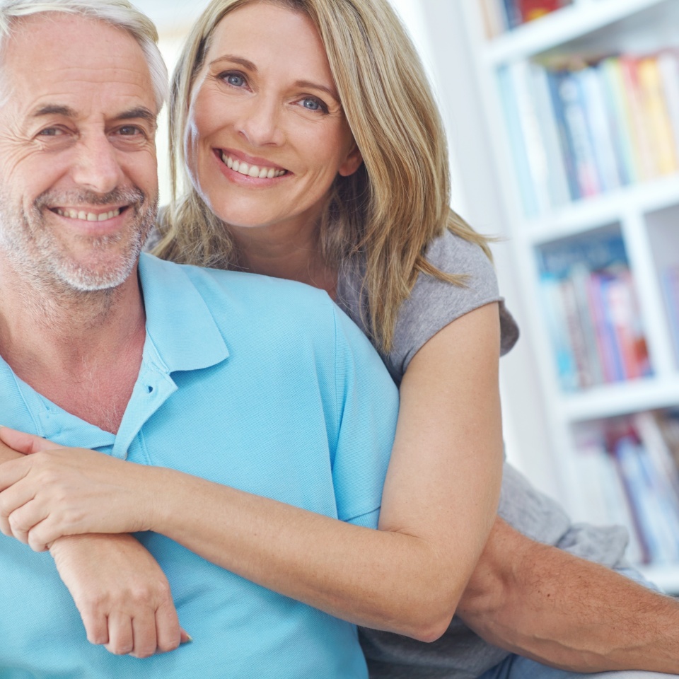 Senior couple, happy and portrait in their home with love, care and support for retirement lifestyle. Commitment of a man and women on a healthy marriage with trust and security on living room couch