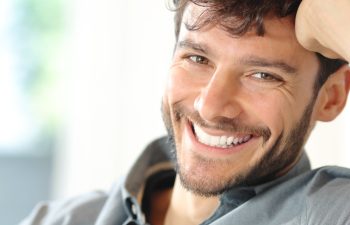 Portrait of a happy man with perfect smile looking at camera at home