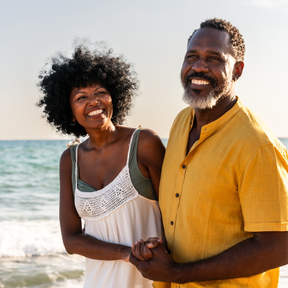Beautiful mature black couple of lovers dating at the seaside - Married african middle-aged couple bonding and having fun outdoors, concepts about relationship, lifestyle and quality of life