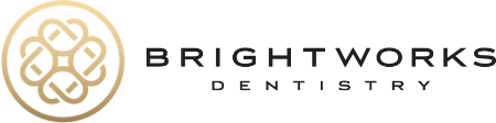 Brightworks Dentistry logo featuring a gold circular geometric symbol on the left and the words "Brightworks Dentistry" in black text on the right.
