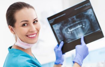 Female dentist with x-ray picture