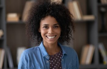 Head shot portrait of happy millennial confident African American businesswoman worker employee looking at camera, profile photo for professional social network, corporate career, female leadership.